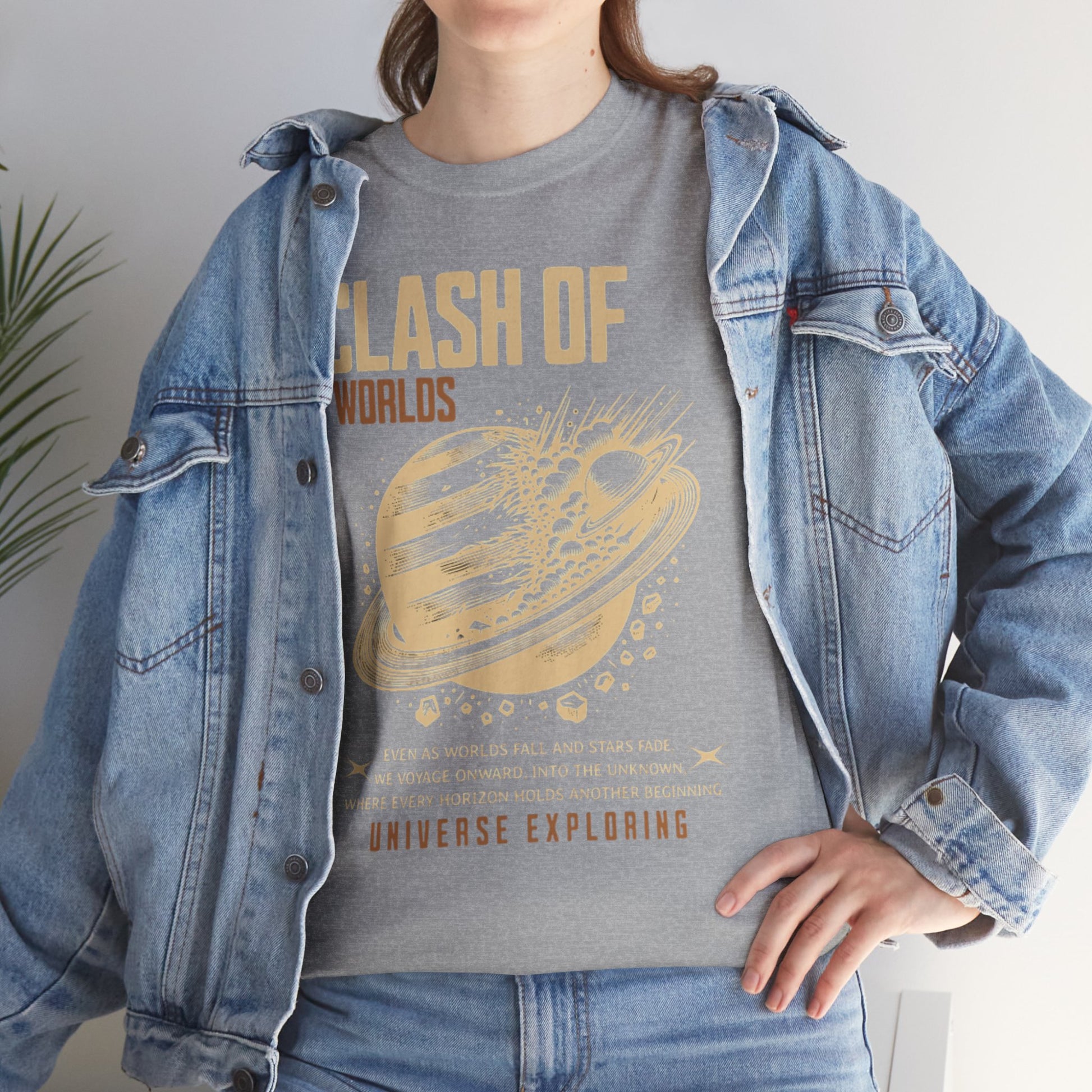 Person wearing a gray t-shirt with 'Clash of Worlds' design and a denim jacket.