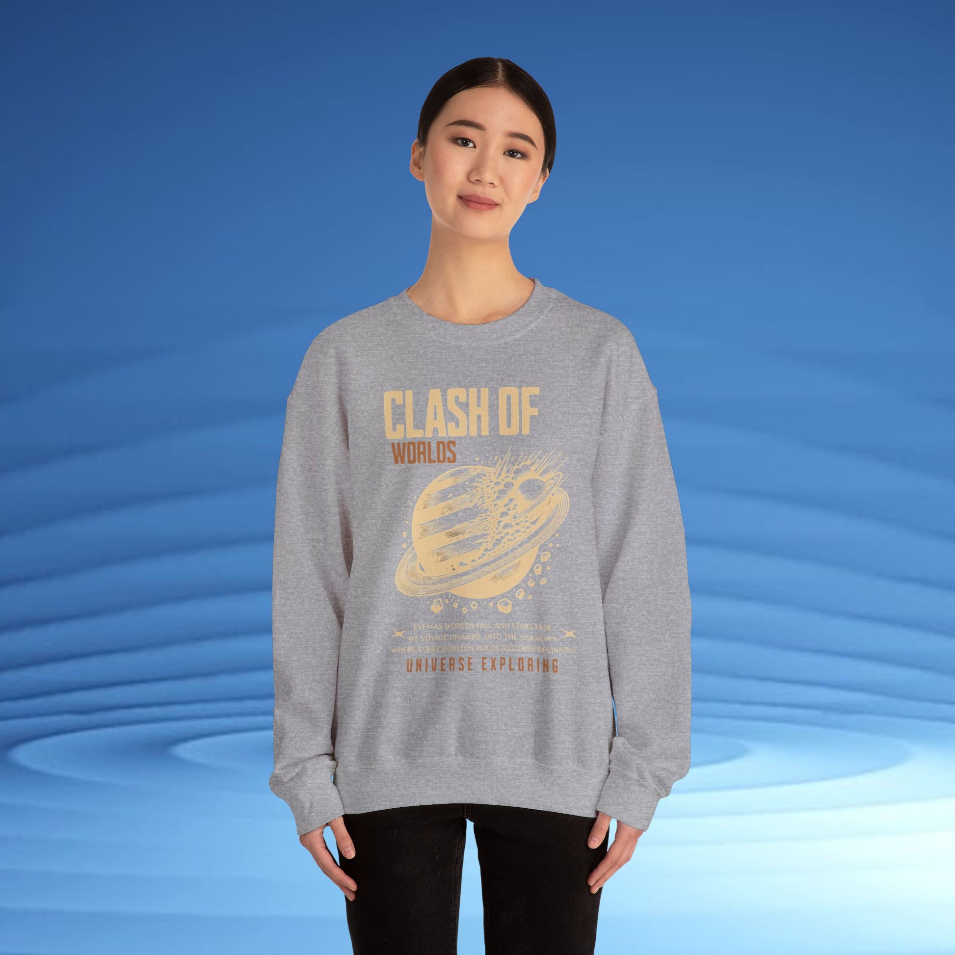 Person wearing a gray sweatshirt with 'Clash of Worlds' design on a blue background