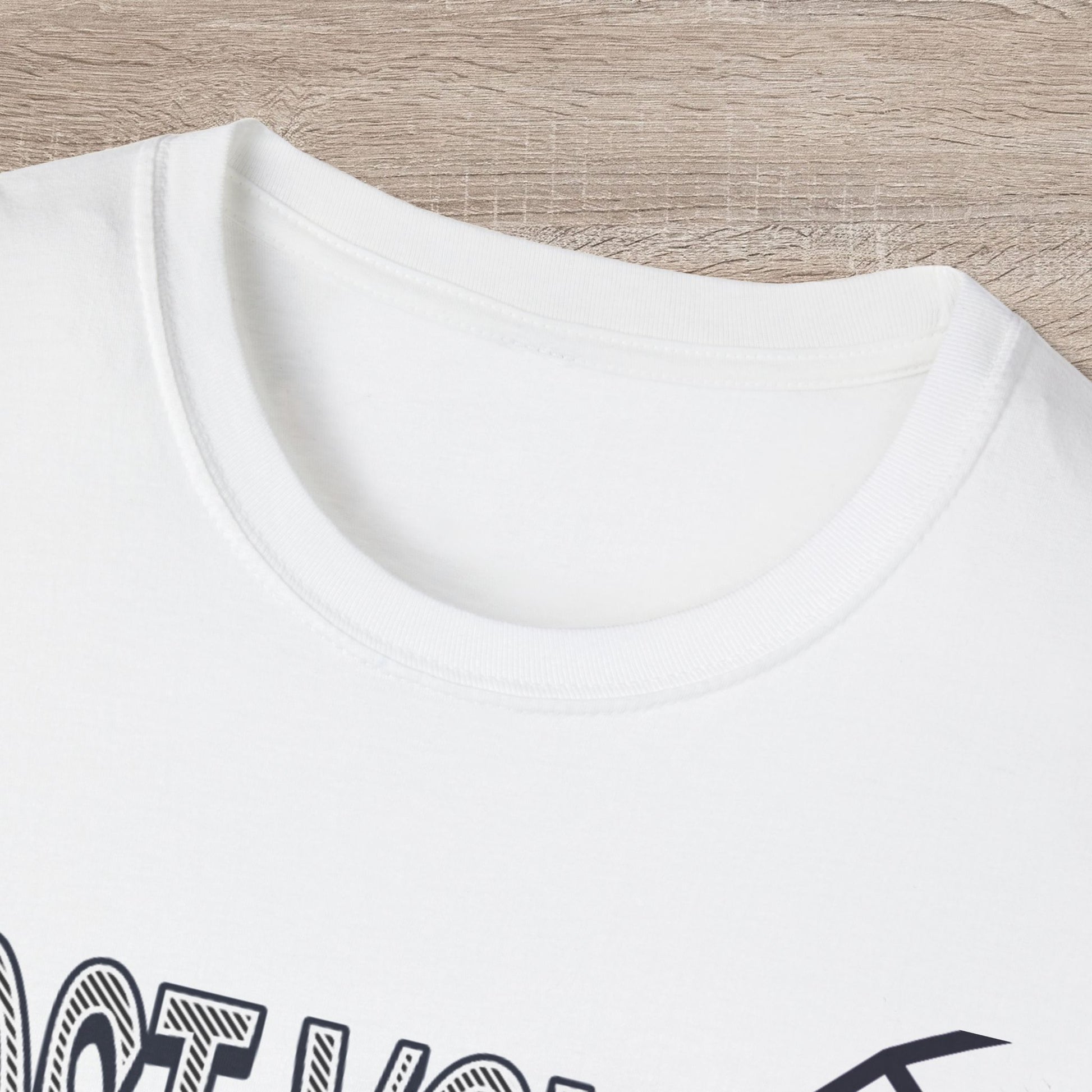 White t-shirt with black text on a wooden surface