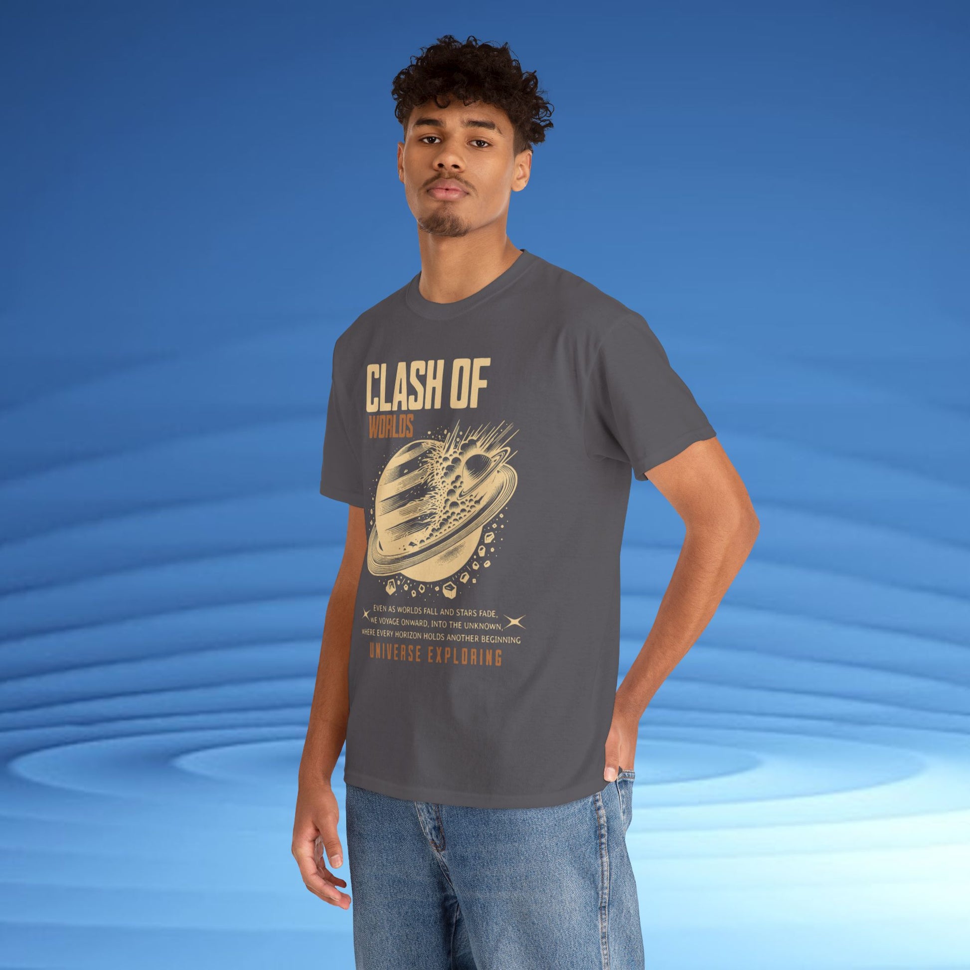 Man wearing a gray t-shirt with 'Clash of Worlds' graphic design on a blue background