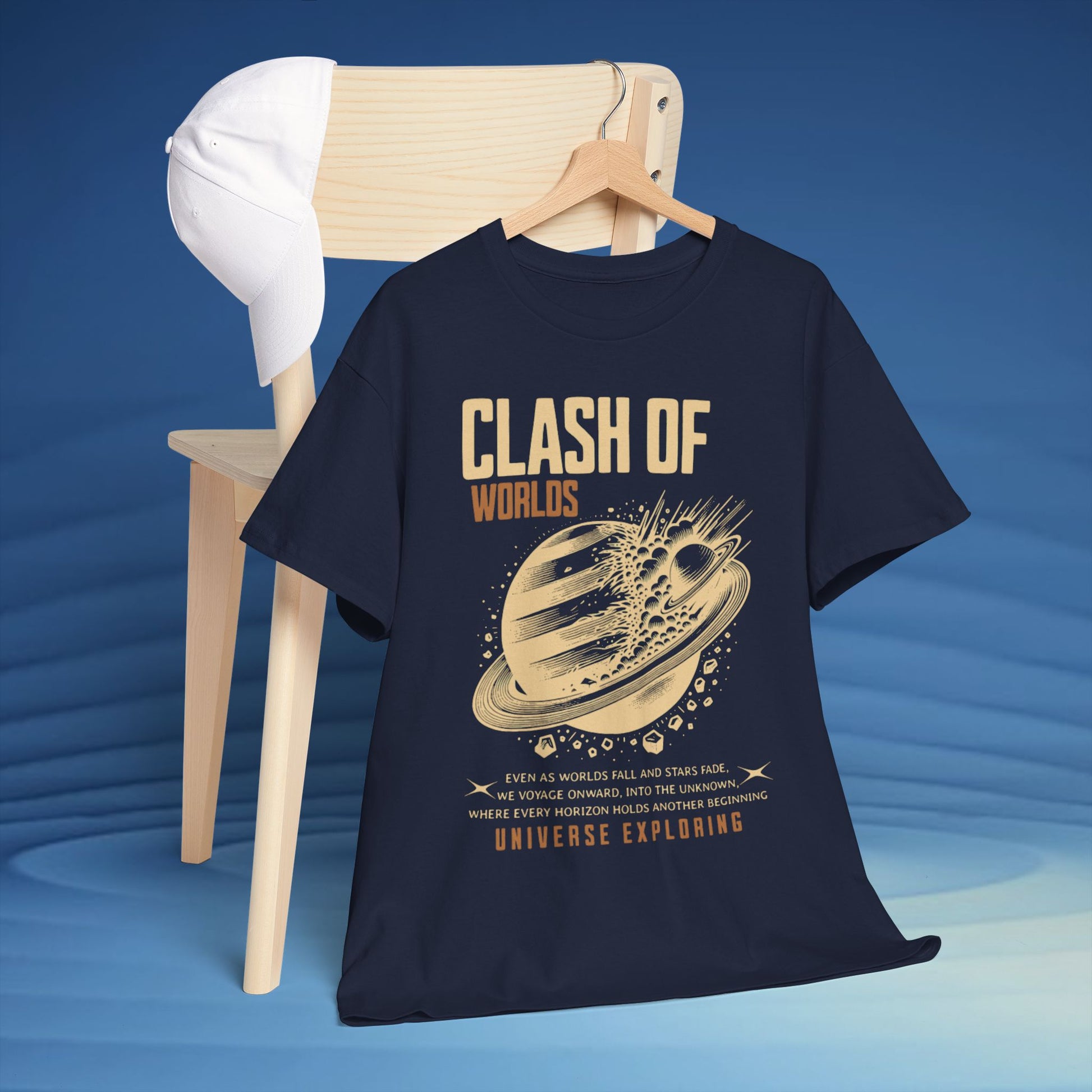 Navy blue t-shirt with 'Clash of Worlds' graphic design on a wooden chair against a blue background CosmoForma