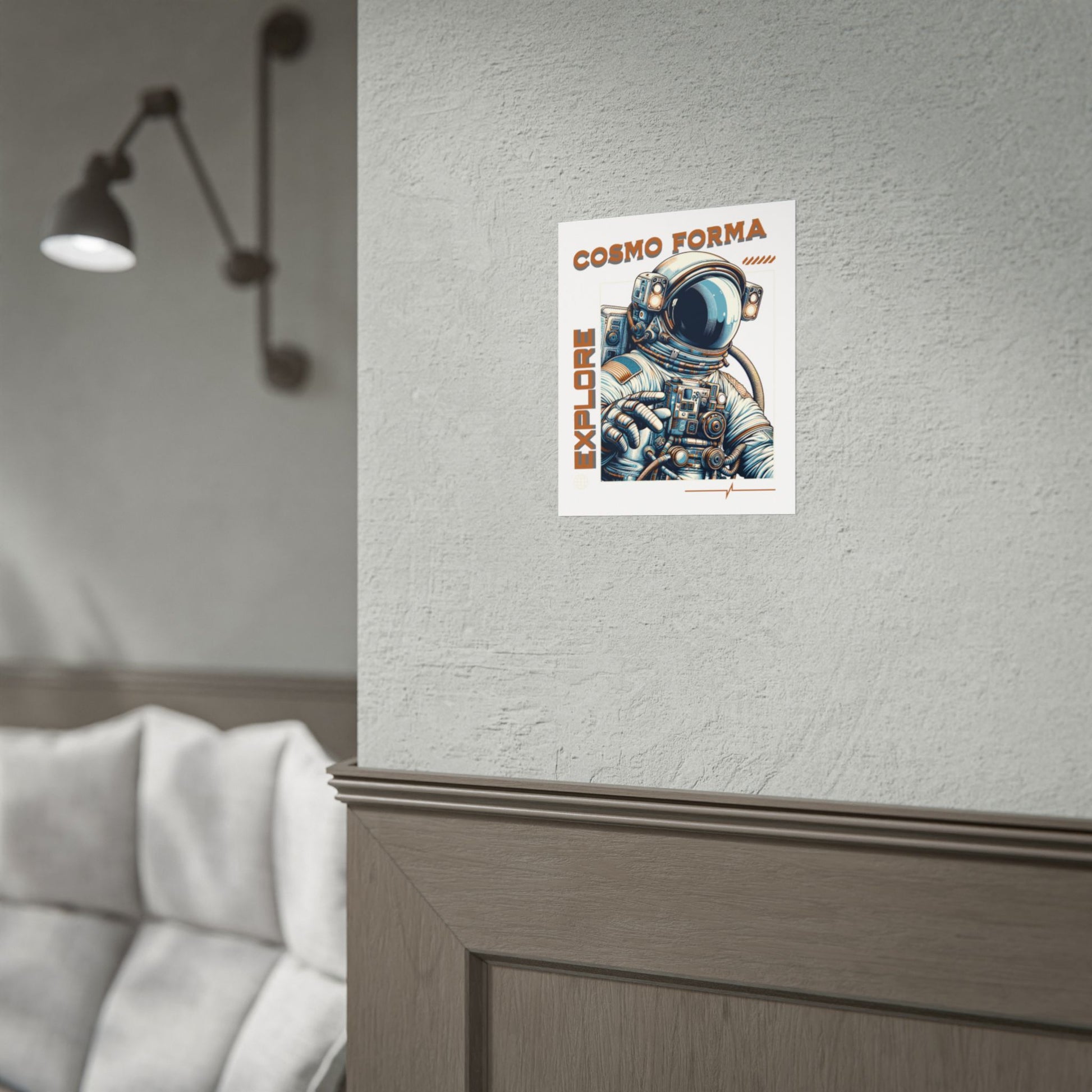 Poster of an astronaut with 'Cosmo Forma' text on a wall next to a sofa.