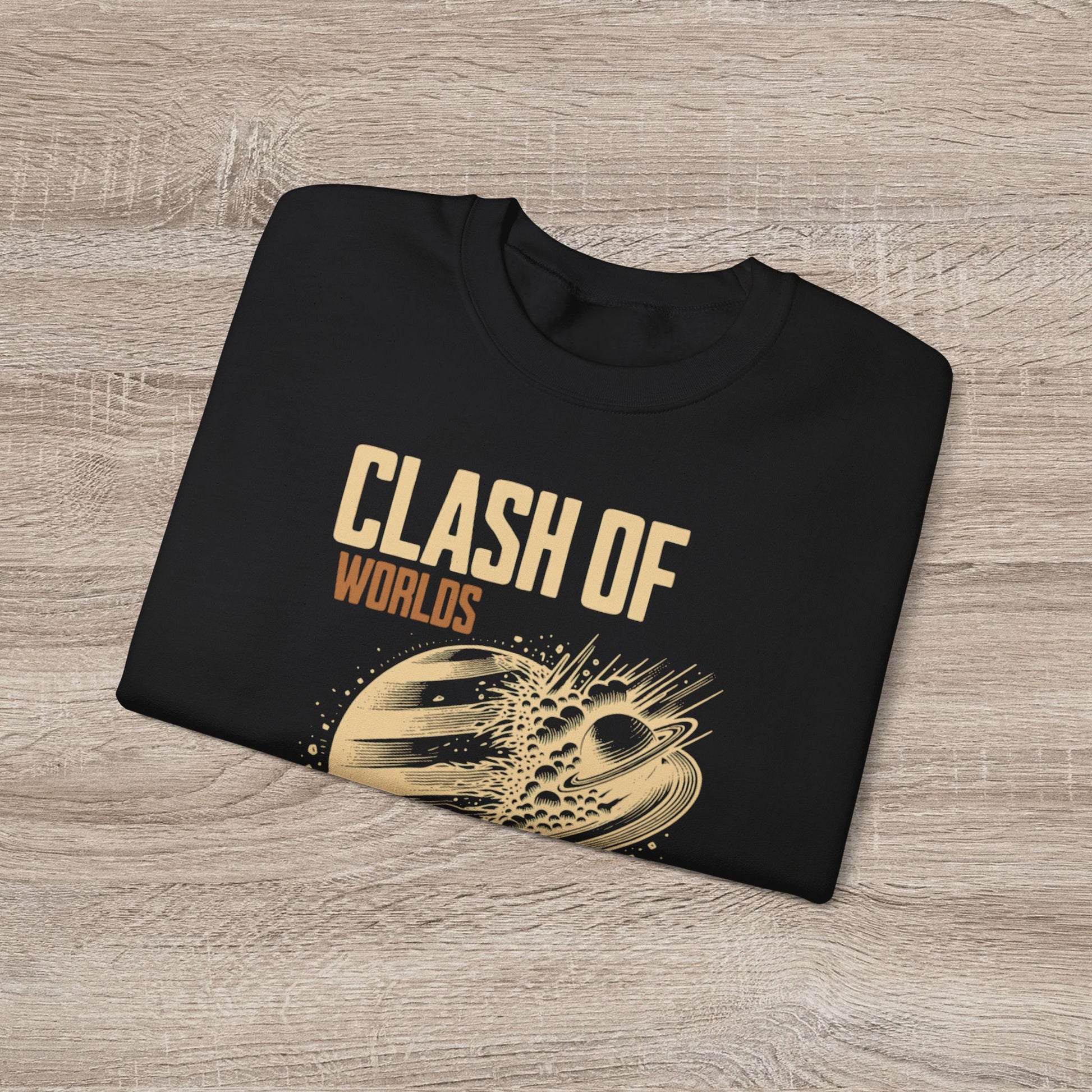Black sweatshirt with 'Clash of Worlds' text and graphic on a wooden surface