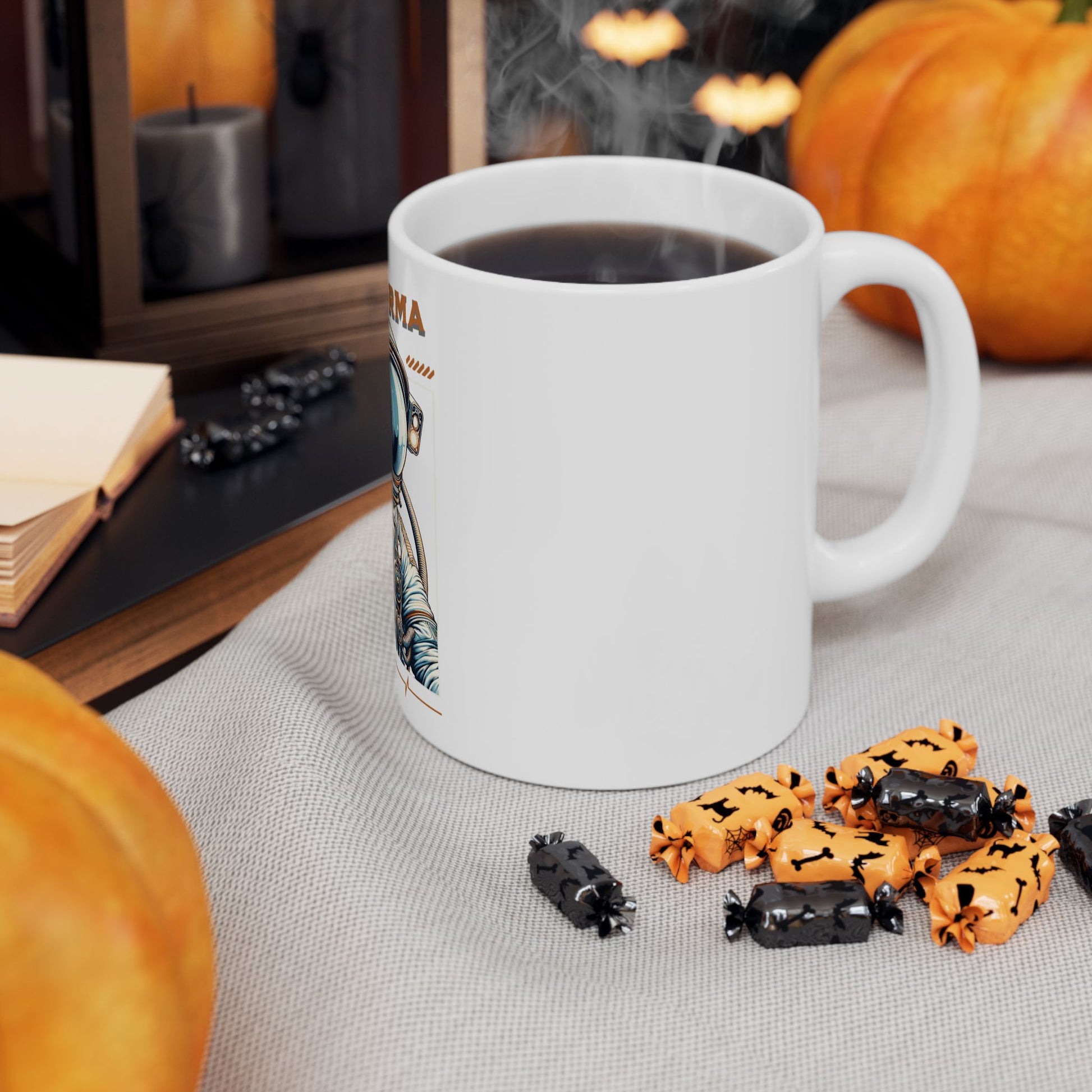 White mug with Halloween-themed design on a table with pumpkins and candies.