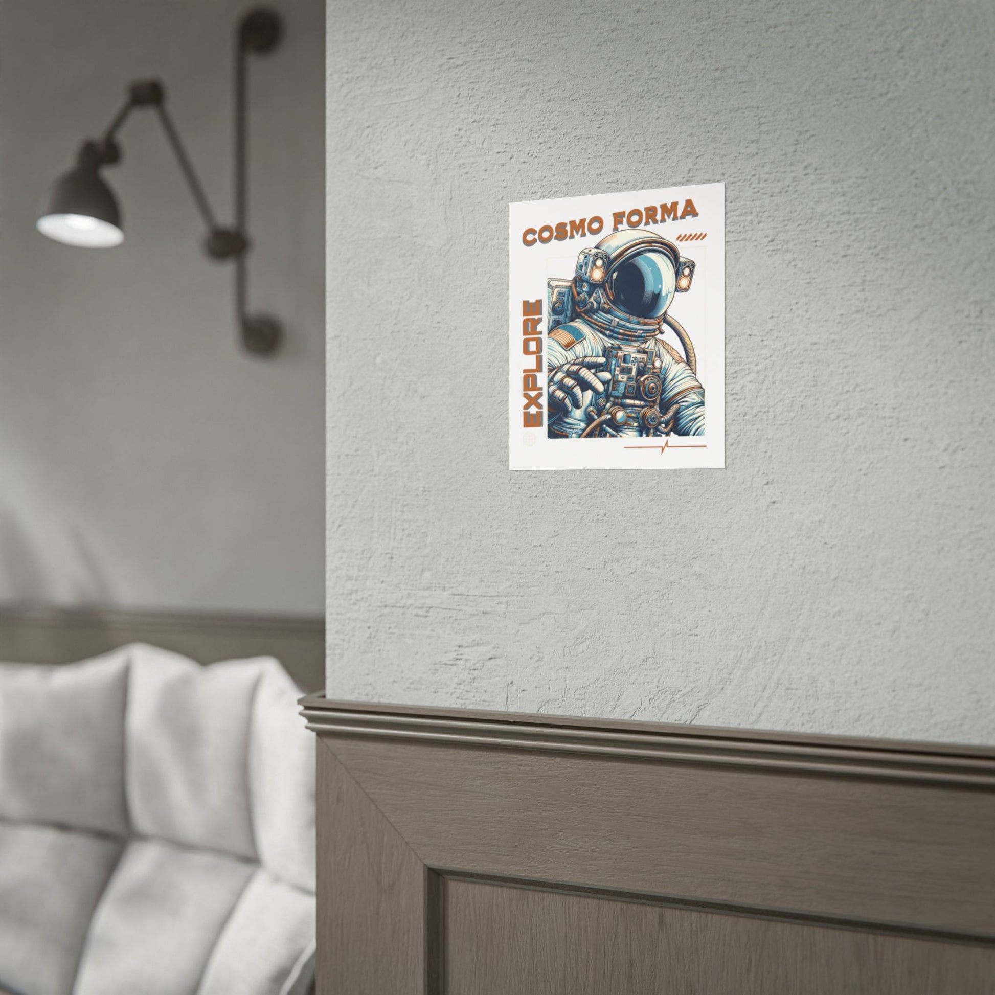 Poster of an astronaut with 'Cosmo Forma' text on a wall next to a sofa.