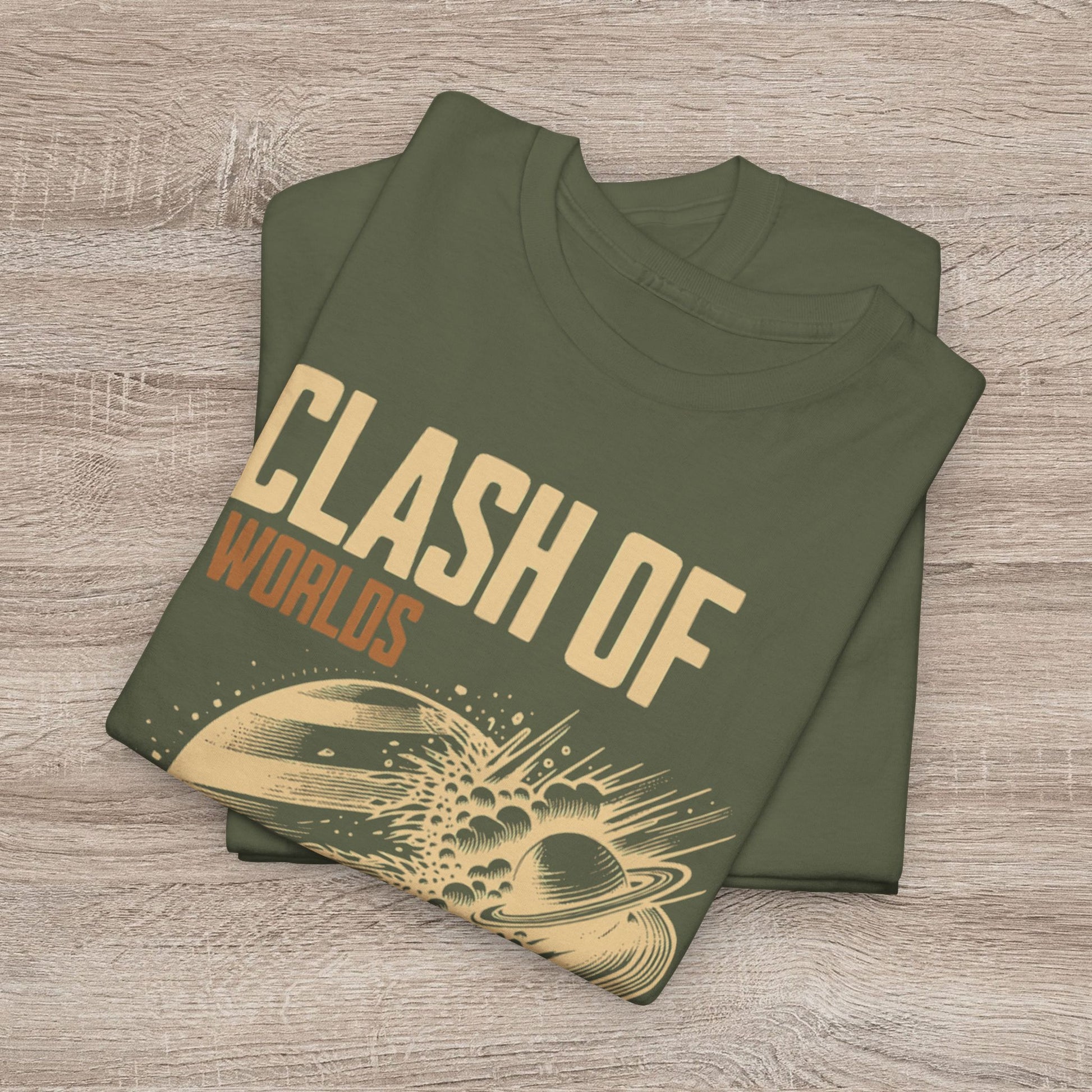 Folded green t-shirt with 'Clash of Worlds' design on a wooden surface