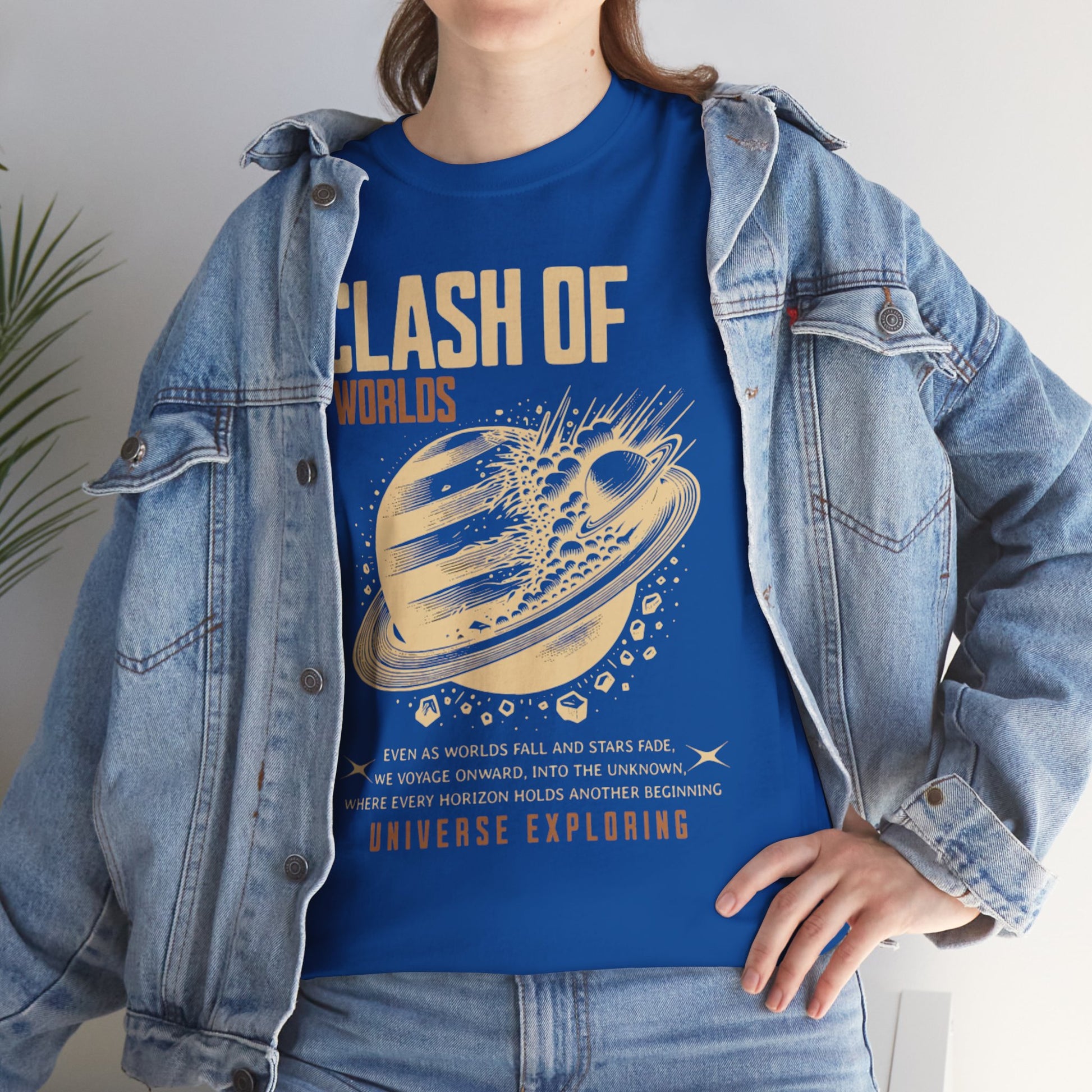 Person wearing a blue t-shirt with 'Clash of Worlds' design and denim jacket.