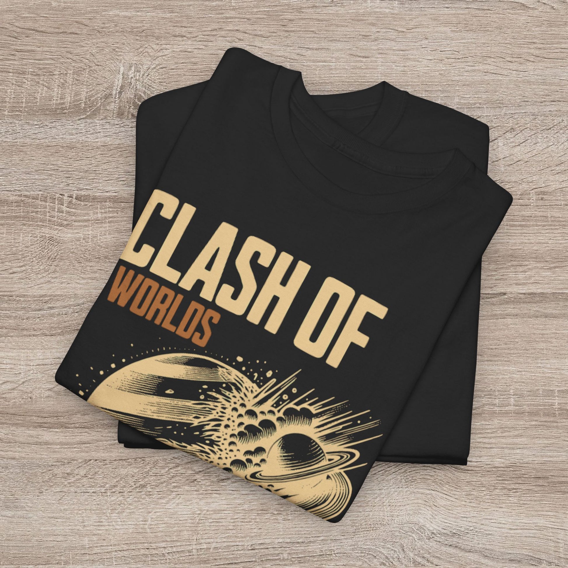 Folded black t-shirt with 'Clash of Worlds' design on a wooden surface